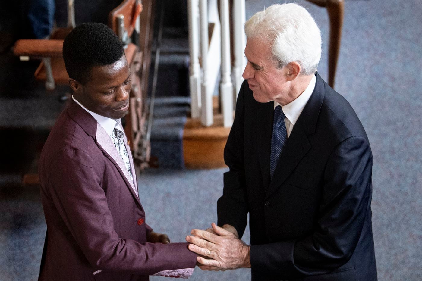Pastor Cliff Jones, right, greets Marcel Njighe, who’s originally from Cameroon, at St. Paul’s Presbyterian Church in Laurel Springs. The congregation prays for Cameroon, which some observers describe as on the verge of civil war. Jones said the people in his flock also want to learn more about the situation, and to do more to help.