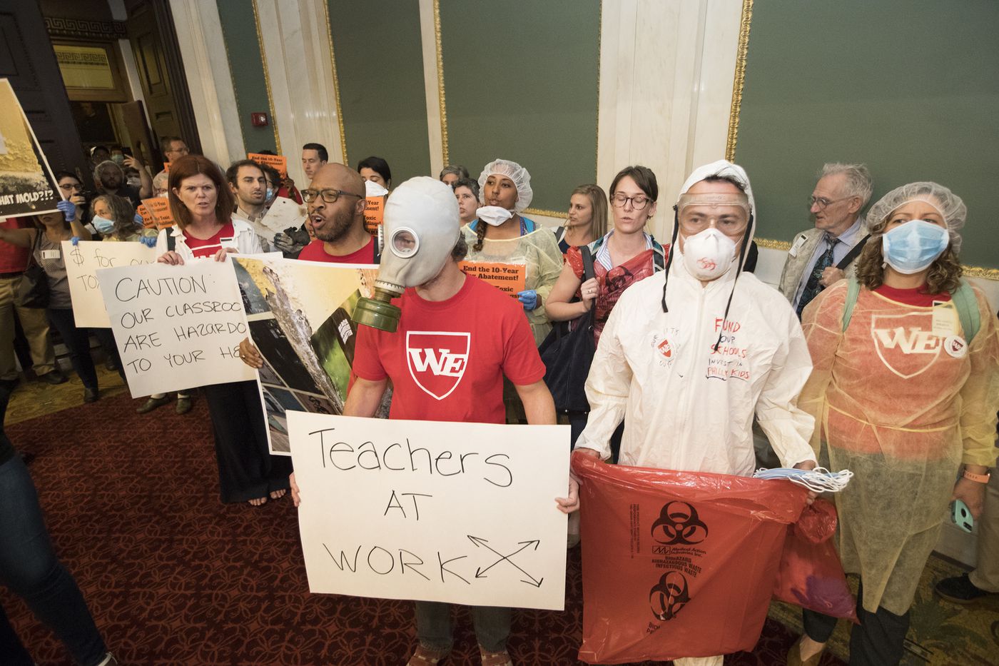 Teachers led by Our City, Our Schools descended on City Council with evidence of the toxic conditions inside their schools on June 5, 2018. They are urging increased funding of schools. They are shown entering Council Chambers.